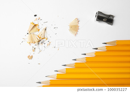 Graphite pencils, shavings and sharpener on white background, top view Graphite pencils, shavings and sharpener on white background, top view 100035227