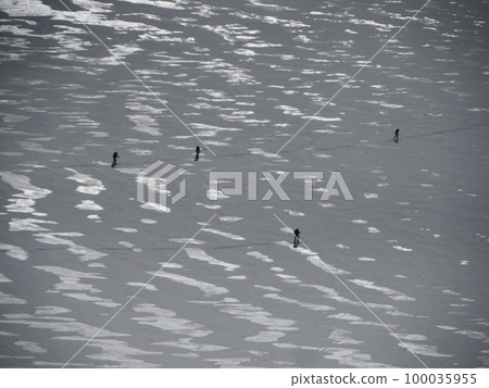 Four skiers walking on snow surface Four skiers walking on snow surface 100035955