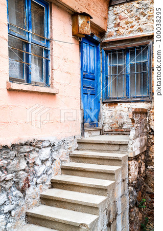 Door and window painted blue colour on facade of old turkish village house, vertical frame Door and window painted blue colour on facade of old turkish village house, vertical frame 100038295