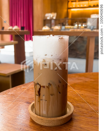 Iced coffee mocha on wooden table in coffee shop 100040696