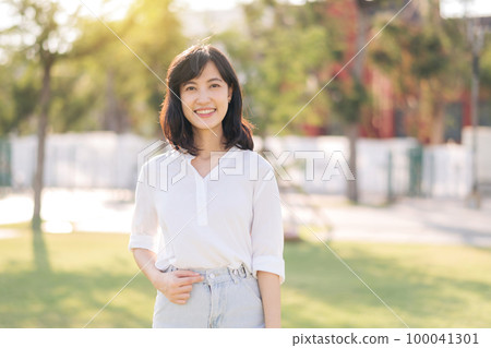 Portrait young beautiful asian woman with happy smile around outdoor park in sunny summer day Portrait young beautiful asian woman with happy smile around outdoor park in sunny summer day 100041301