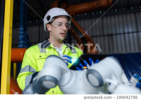 Engineer male using tablet control and checking system robot arm automate. Engineer male using tablet control and checking system robot arm automate. 100042786