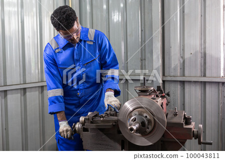 Engineering worker man African American wearing uniform safety working machine lathe metal brake. Engineering worker man African American wearing uniform safety working machine lathe metal brake. 100043811