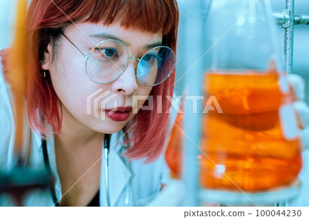 women scientist are working research and test chemical with test tubes in laboratory. 100044230