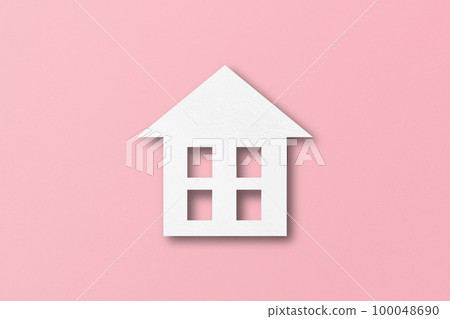White paper cut out house shape isolated on pink paper background. 100048690