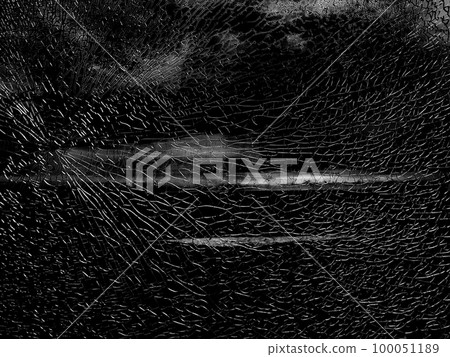 Broken glass with white grey cracks. Abstract cracked window on dark black Broken glass with white grey cracks. Abstract cracked window on dark black 100051189