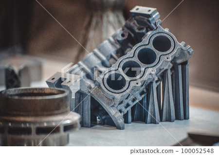 Man is holding object printed on metal 3d printer. Object printed in laser sintering machine. Modern 3D printer printing from metal powder. Progressive additive DMLS, SLM, SLS 3d printing technology 100052548