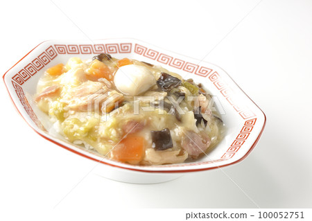 A Chinese rice bowl served on an octagonal Chinese dish is photographed against a white background 100052751