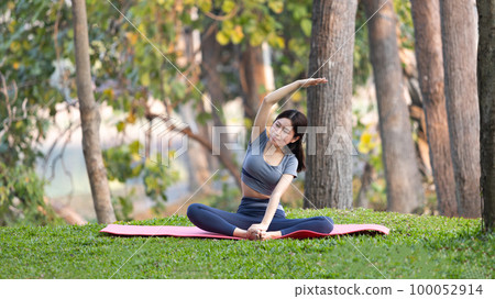 Asian woman doing yoga in nature in the forest, Meditation and breathing exercises, Treat ADHD and train your mind to be calm, Healthy exercise, Mindfulness, Homeopathy, Park yoga. 100052914