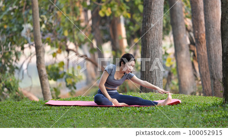 Asian woman doing yoga in nature in the forest, Meditation and breathing exercises, Treat ADHD and train your mind to be calm, Healthy exercise, Mindfulness, Homeopathy, Park yoga. Asian woman doing yoga in nature in the forest, Meditation and breathing exercises, Treat ADHD and train your mind to be calm, Healthy exercise, Mindfulness, Homeopathy, Park yoga. 100052915
