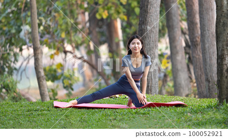 Asian woman doing yoga in nature in the forest, Meditation and breathing exercises, Treat ADHD and train your mind to be calm, Healthy exercise, Mindfulness, Homeopathy, Park yoga. Asian woman doing yoga in nature in the forest, Meditation and breathing exercises, Treat ADHD and train your mind to be calm, Healthy exercise, Mindfulness, Homeopathy, Park yoga. 100052921
