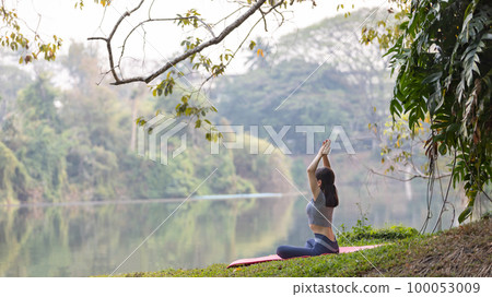 Asian woman doing yoga in nature in the forest, Meditation and breathing exercises, Treat ADHD and train your mind to be calm, Healthy exercise, Mindfulness, Homeopathy, Park yoga. 100053009