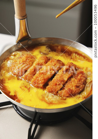 Katsudon being cooked in a pot Katsudon being cooked in a pot 100053496
