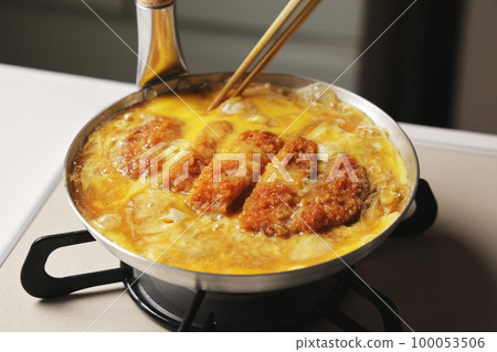 Katsudon being cooked in a pot Katsudon being cooked in a pot 100053506