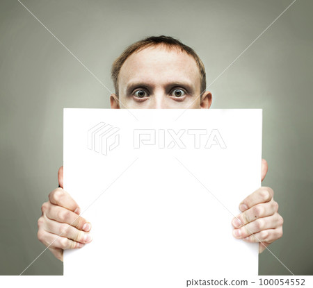 Surprised man holding blank sign paper 100054552