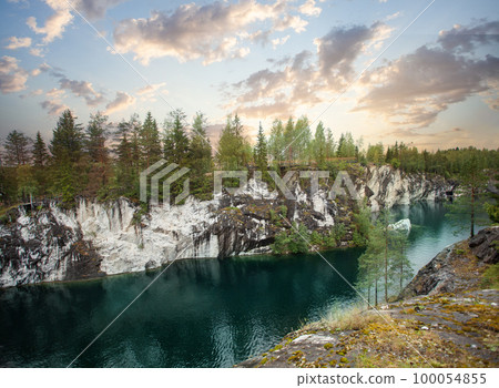 Beautiful landscape of cloudy sunset, green woods and cold blue mountain river Beautiful landscape of cloudy sunset, green woods and cold blue mountain river 100054855