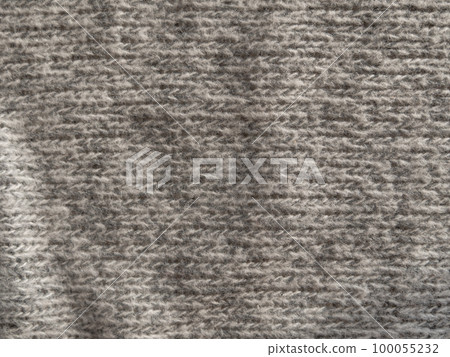 Gray knitted texture woolen fabric Textile knit pattern wallpaper background surface design. Handmade shop cozy backdrop Gray knitted texture woolen fabric Textile knit pattern wallpaper background surface design. Handmade shop cozy backdrop 100055232