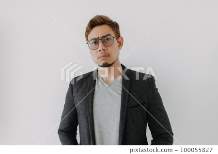 Serious and aggressive man in black suit isolated on white. 100055827