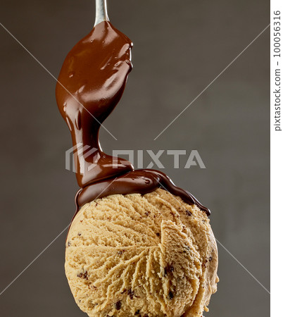 melted chocolate sauce flowing on ice cream melted chocolate sauce flowing on ice cream 100056316
