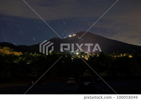 Mt. Fuji looking up from the Gotemba trailhead at night and light trails aiming for the summit Mt. Fuji looking up from the Gotemba trailhead at night and light trails aiming for the summit 100058049