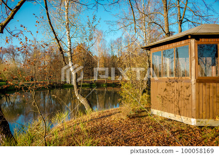 Pond with a little island and a gazebo in the evening 100058169