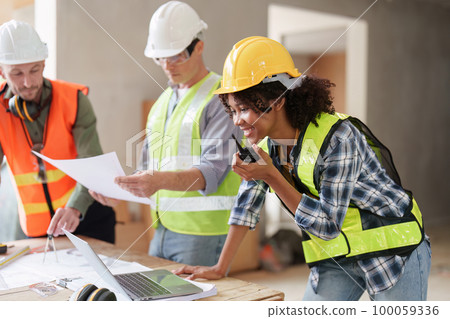 American African Foreman builder woman at construction site. Foreman construction and Engineer working at construction site 100059336