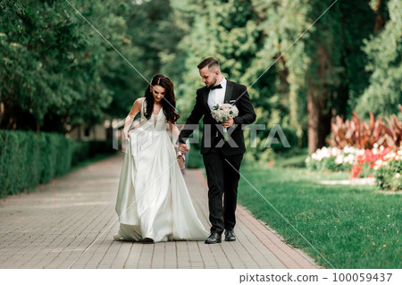 beautiful couple newlyweds on a walk in the city Park 100059437