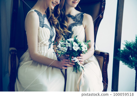 close up. bridesmaids with a wedding bouquet. close up. bridesmaids with a wedding bouquet. 100059518