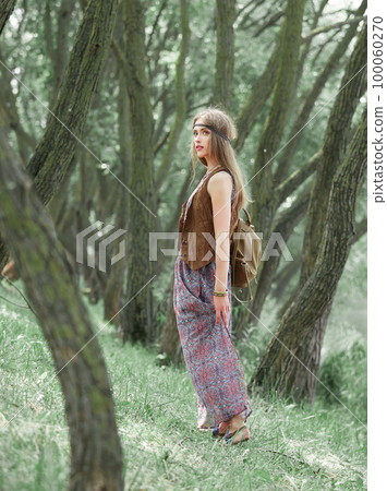 attractive hippie girl standing among the trees in the forest attractive hippie girl standing among the trees in the forest 100060270