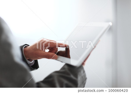 close up.blurred image businessman presses on the screen of a digital tablet.photo with copy space 100060420