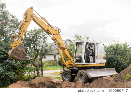 A excavator is digging on outdoors in an industrial site. Excavation works 100060747
