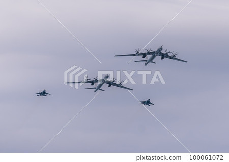 Russia. Kronstadt. July 31, 2022. A flight of Tu-142M3 and MIG-29KUB aircraft at the naval parade. Russia. Kronstadt. July 31, 2022. A flight of Tu-142M3 and MIG-29KUB aircraft at the naval parade. 100061072