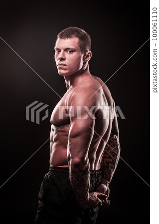 side view. male bodybuilder holding his hands behind his back side view. male bodybuilder holding his hands behind his back 100061110