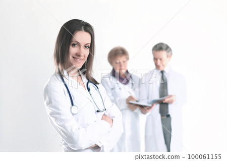 confident female doctor therapist on blurred background of colleagues confident female doctor therapist on blurred background of colleagues 100061155