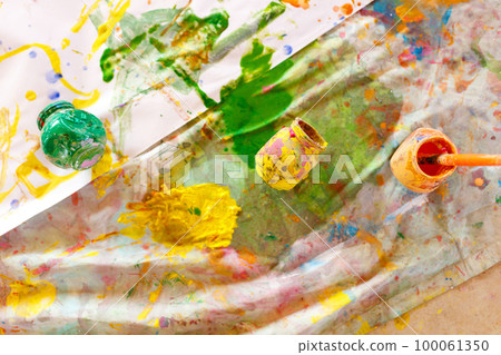 Paints and brushes. Used paint palette, watercolors, brush and dirty colored bottles - art lesson Paints and brushes. Used paint palette, watercolors, brush and dirty colored bottles - art lesson 100061350