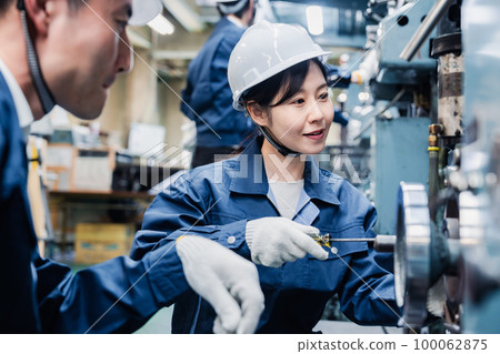 Foreign workers being taught how to work at a factory Foreign workers being taught how to work at a factory 100062875