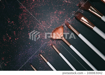 nine professional makeup brushes on a black background nine professional makeup brushes on a black background 100063042