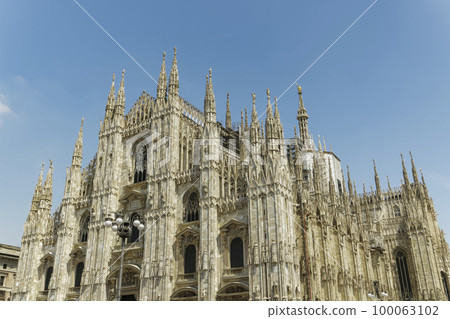 Milan, Italy Duomo di Milano front and side view. External day view of the Roman Catholic cathedral church of Milan. 100063102