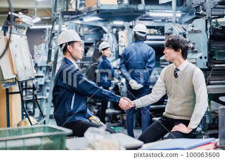 A male student having a job interview at a factory A male student having a job interview at a factory 100063600