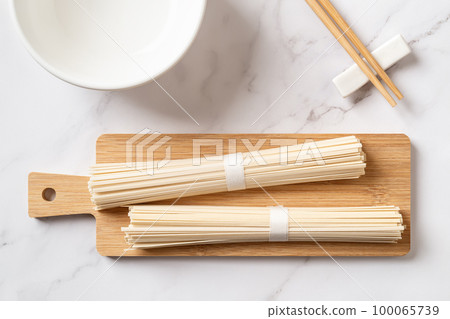 Raw udon nudles prepared for cooking. Raw udon nudles prepared for cooking. 100065739