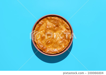 Phyllo cake above view, minimalist on a blue background 100066804
