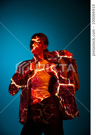 Futuristic style portrait of young woman with digital neon filter lights on clothes over dark blue background. Concept of art, fashion, cyberpunk, futurism and creativity 100066919