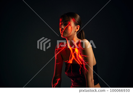 Creative portrait of young sensual woman with digital neon filter lights on body over dark mode background. Concept of digital art, fashion, cyberpunk, futurism and creativity 100066930