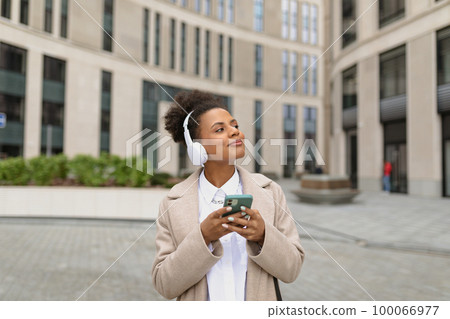 african young woman student during break from study enjoy weather and music african young woman student during break from study enjoy weather and music 100066977