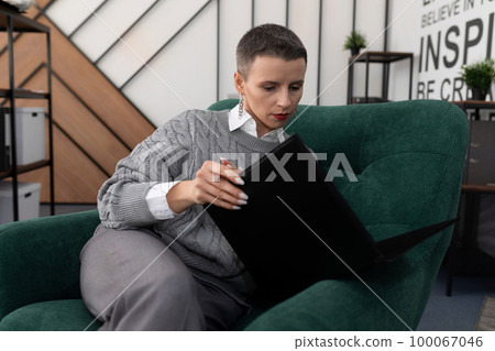 financier woman working with folders of papers in the office financier woman working with folders of papers in the office 100067046