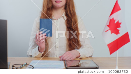 Canadian woman consular officer showing passport immigrant, work visa, citizenship. Visa Application online form immigration concept. Visa approval. Canadian woman consular officer showing passport immigrant, work visa, citizenship. Visa Application online form immigration concept. Visa approval. 100068780