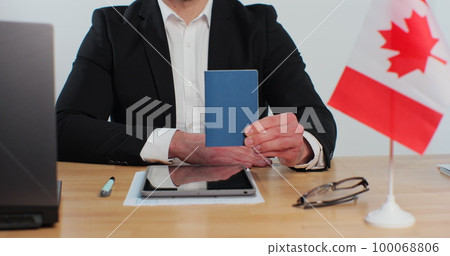 Canadian man consular officer showing passport immigrant, work visa, citizenship. Visa Application online form immigration concept. Visa approval. 100068806