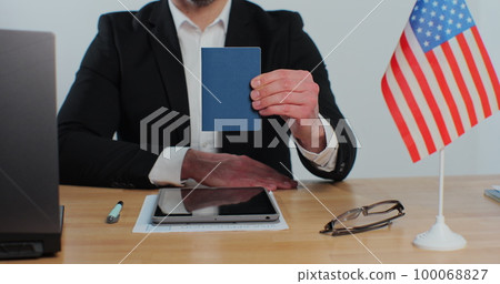 American consular officer showing passport immigrant, work visa, citizenship. Visa Application online form immigration concept. Visa approval. American consular officer showing passport immigrant, work visa, citizenship. Visa Application online form immigration concept. Visa approval. 100068827