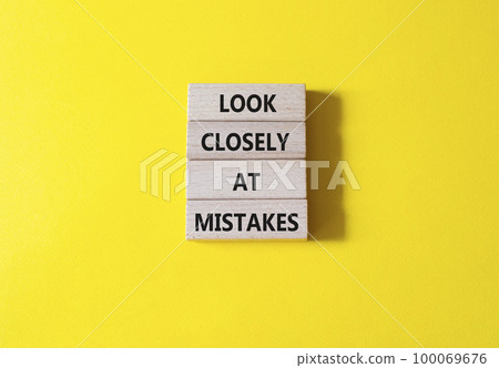 Look closely at mistakes symbol. Wooden blocks with words Look closely at mistakes. Beautiful yellow background. Business and Look closely at mistakes concept. Copy space. 100069676