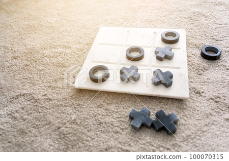 Marble Tic Tac Toe or OX board game on soft carpet with copy space. concept of strategy, risk, competition in business. 100070315